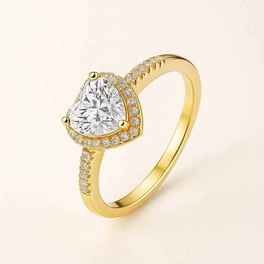 Gold Plated ring with a large central diamond and smaller diamonds on the band against a light beige background