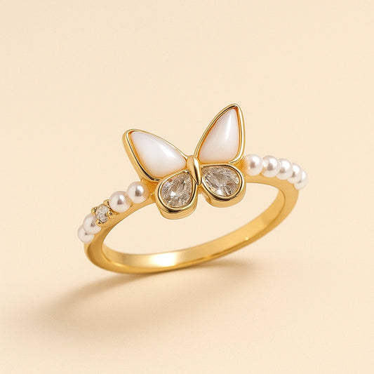 Gold-plated butterfly ring with white enamel wings, crystal inlays, and pearl accents on a 925 silver band