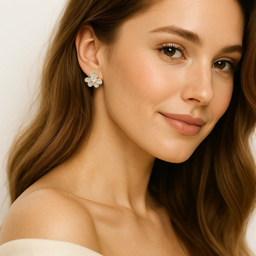 Close-up of a woman wearing a floral earring with a neutral background