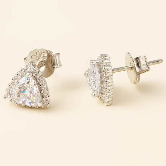 Pair of diamond earrings on a beige background