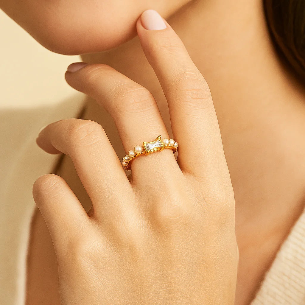 Golden ring with a diamond on a hand against a neutral background
