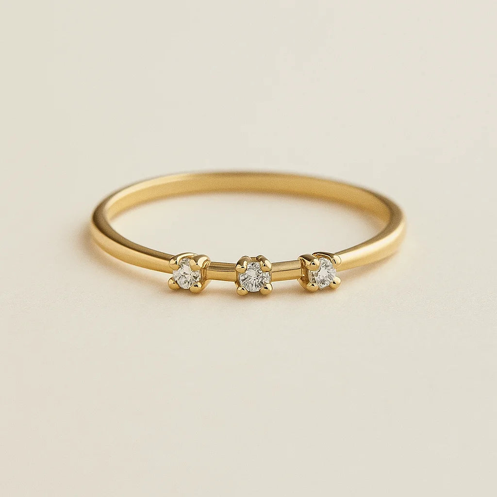 Golden ring with small diamonds on a beige background