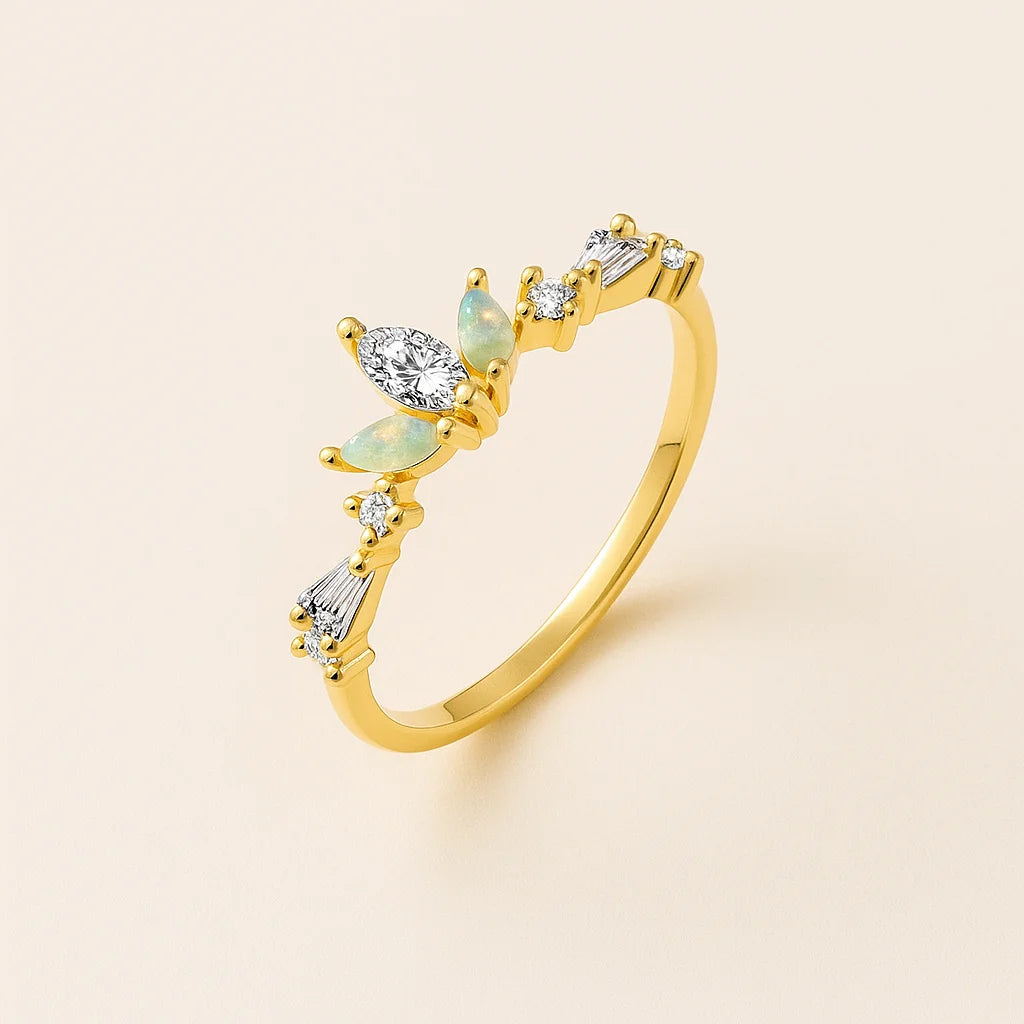 Golden ring with gemstones on a beige background