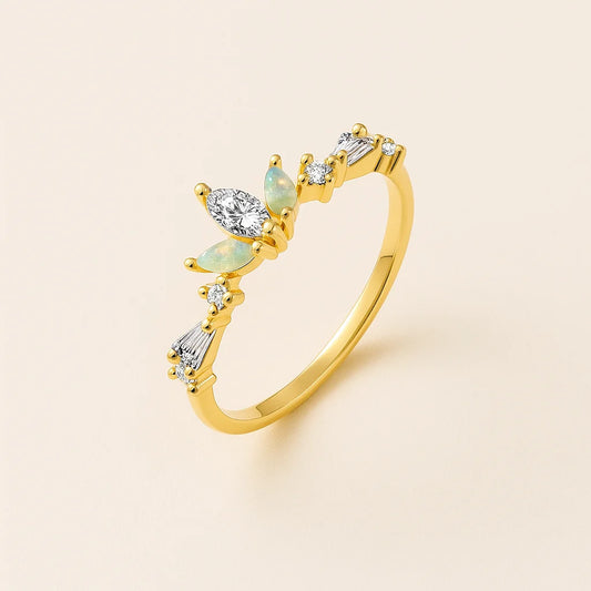 Golden ring with gemstones on a beige background