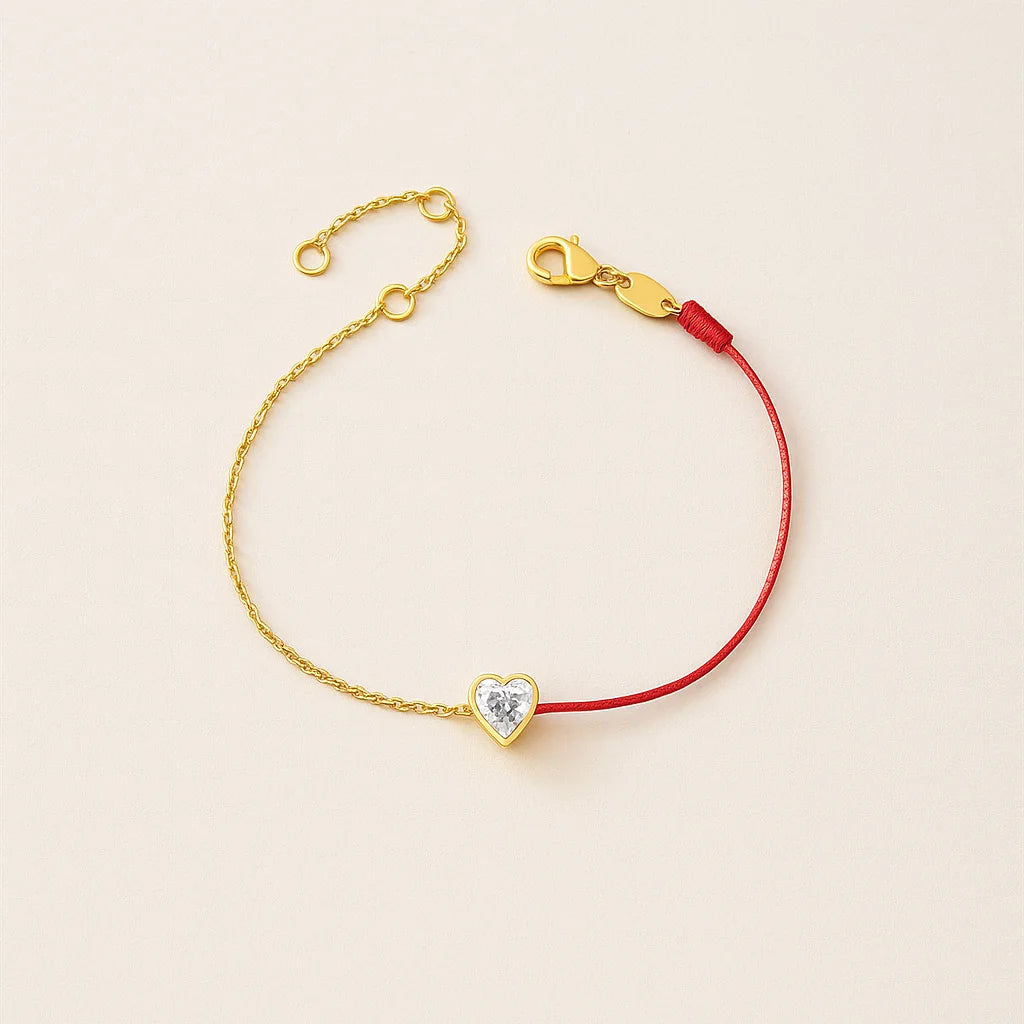 Bracelet with a heart-shaped charm on a beige background