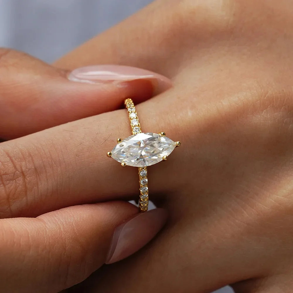 Gold ring with a large diamond on a person's finger