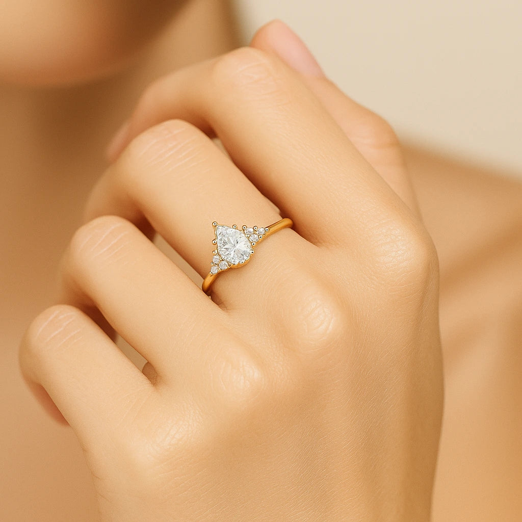 Gold plated ring with a diamond on a hand against a neutral background