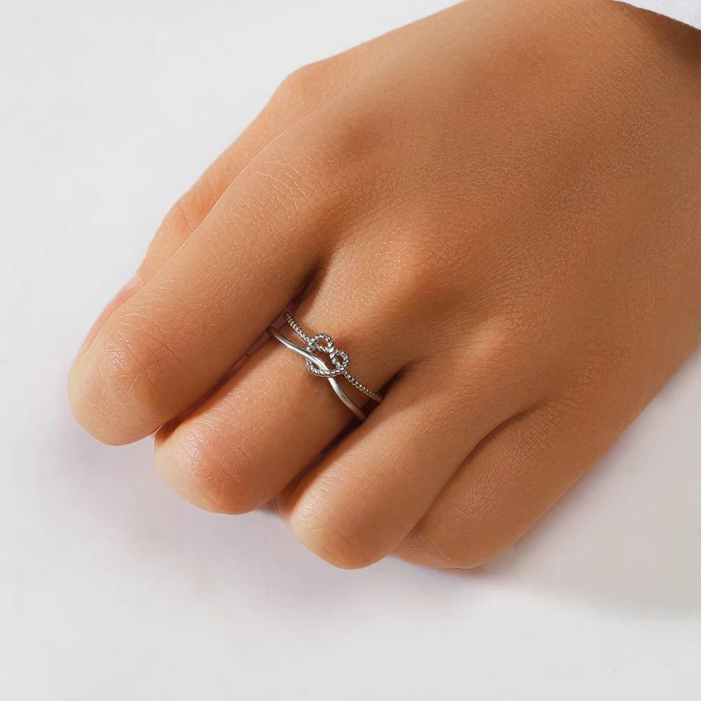 925 silver women’s ring with minimalist open heart design on a light background