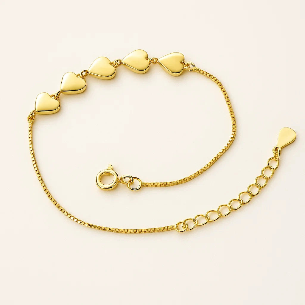 A beautiful gold-plated 925 sterling silver bracelet featuring five polished heart-shaped links.