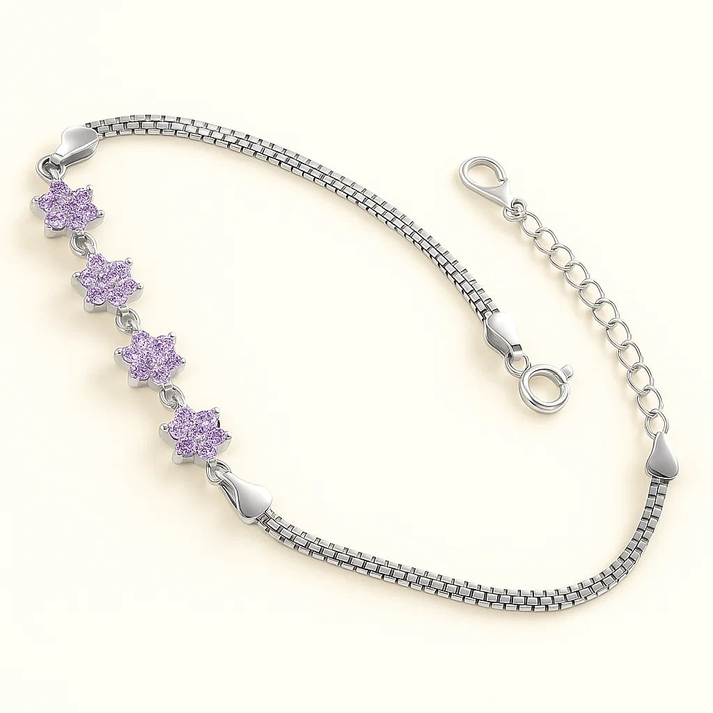 Silver bracelet with purple flower-shaped charms on a light beige background
