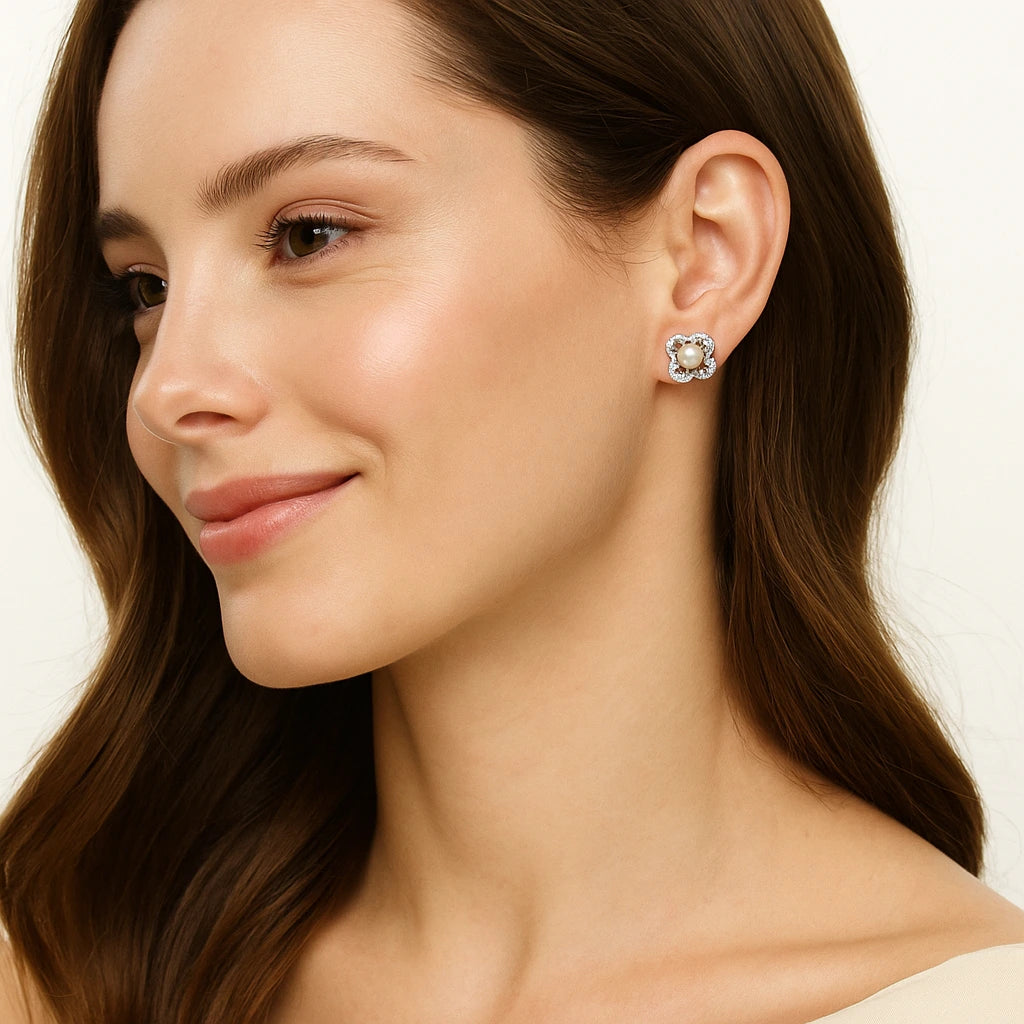 Close-up of a woman wearing a diamond earring on a plain background
