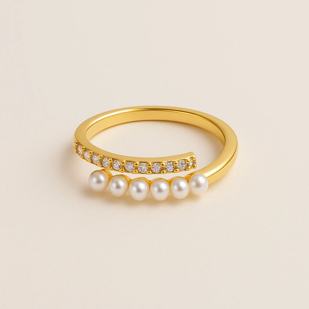 Golden ring with pearls and small diamonds on a beige background