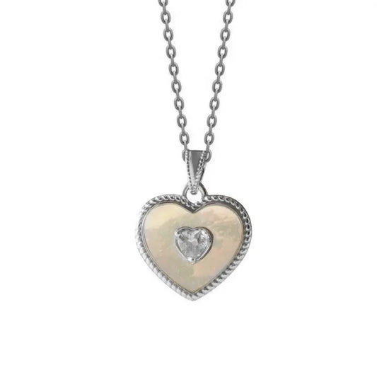 Heart-shaped pendant with a diamond on a chain against a white background