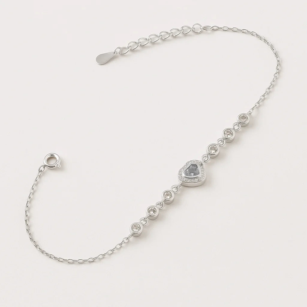 925 sterling silver bracelet with a central pink heart charm and a line of sparkling cubic zirconia stones.