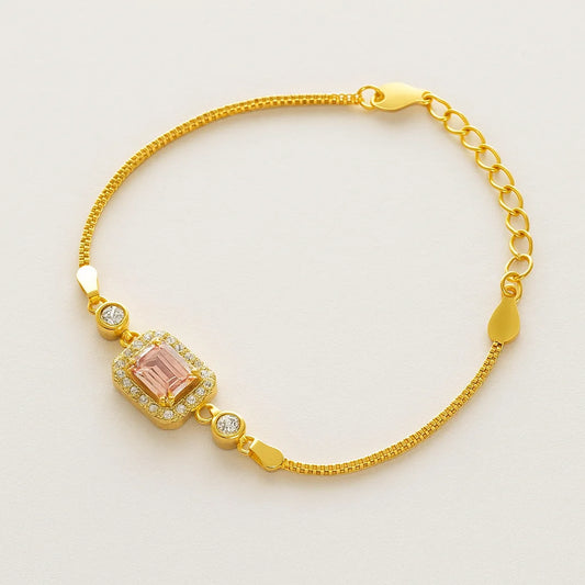 A gold-plated 925 sterling silver bracelet featuring a rectangular pink zircon stone surrounded by smaller clear zircons.