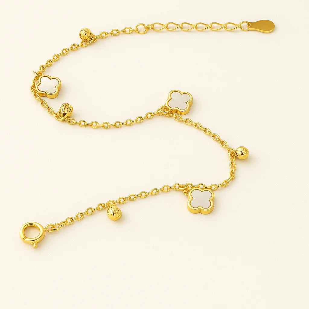 A beautiful gold-plated sterling silver bracelet featuring multiple mother-of-pearl clover charms and polished beads.