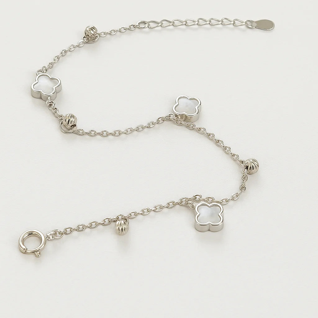 A beautiful gold-plated sterling silver bracelet featuring multiple mother-of-pearl clover charms and polished beads.