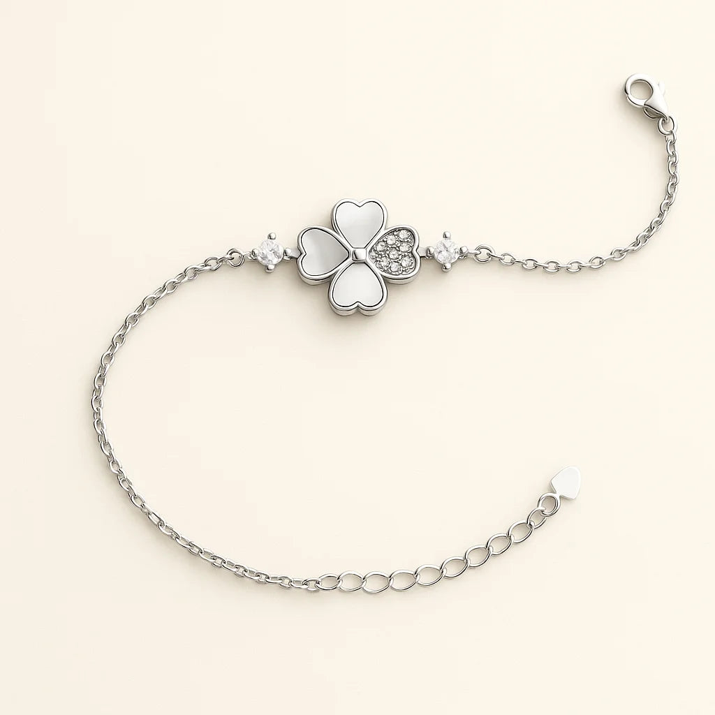 A beautiful sterling silver bracelet with a four-leaf clover charm featuring mother-of-pearl and cubic zirconia details.
