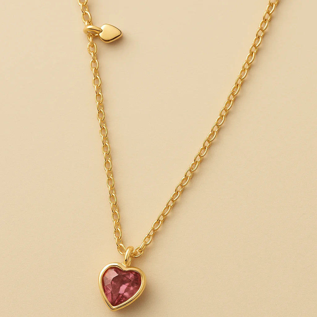 A 925 sterling silver and a gold-plated necklace, each with a heart-shaped stone pendant in pink or magenta.