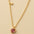 A 925 sterling silver and a gold-plated necklace, each with a heart-shaped stone pendant in pink or magenta.