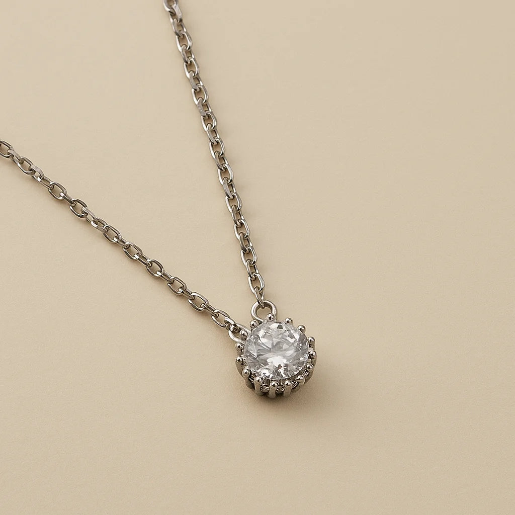 A 925 sterling silver and a gold-plated necklace, each with a round solitaire stone framed by a pavé halo.