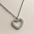 A 925 sterling silver and a gold-plated necklace, each with a heart-shaped pendant completely paved in sparkling cubic zirconia.