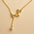 A 925 sterling silver and a gold-plated necklace, each with two intertwined hearts and a hanging pearl charm.