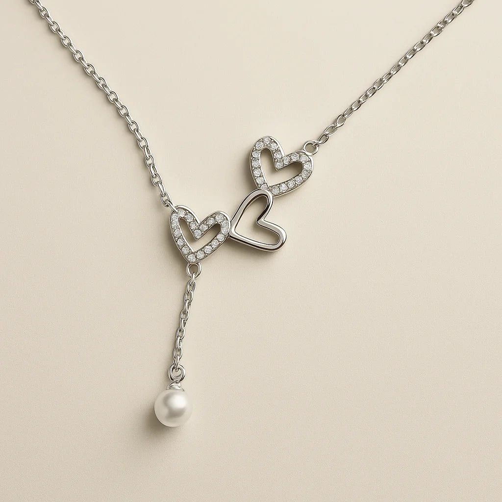 A 925 sterling silver and a gold-plated necklace, each with two intertwined hearts and a hanging pearl charm.