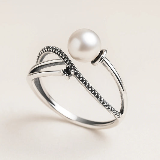 Silver Ring with a pearl on a light beige background