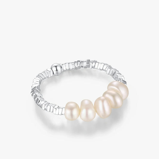 Silver ring with pearls on a white background