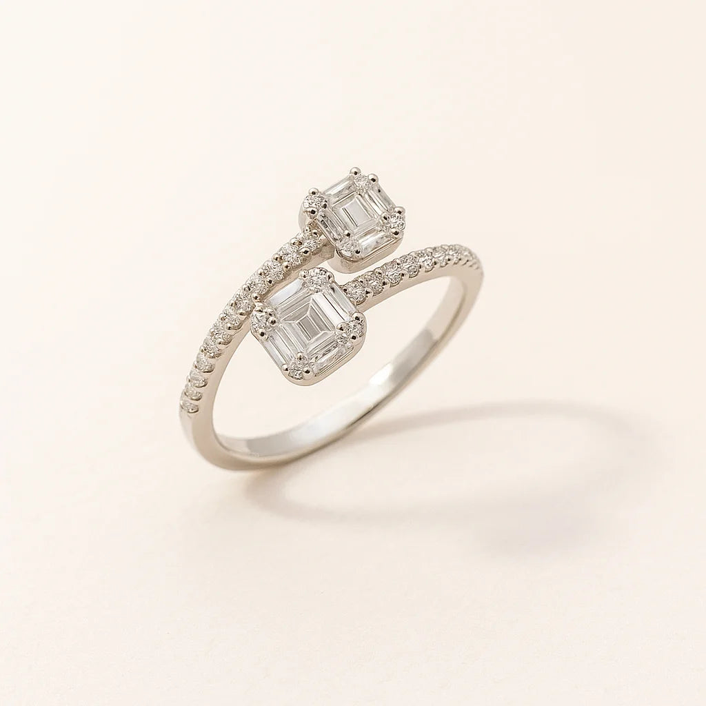 A unique twin-stone 925 sterling silver ring with a bypass design and pavé details.