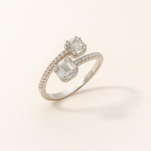 A unique twin-stone 925 sterling silver ring with a bypass design and pavé details.