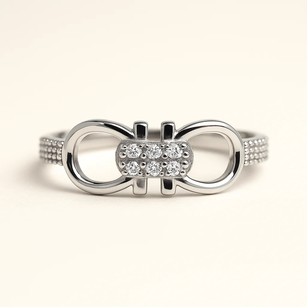 A 925 sterling silver ring with a central pavé-set interlocking link and textured pavé band.