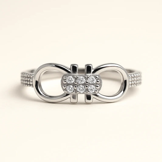 A 925 sterling silver ring with a central pavé-set interlocking link and textured pavé band.