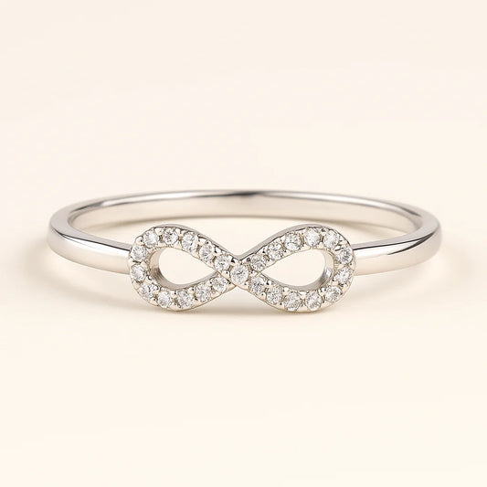 A 925 sterling silver ring with a central infinity symbol paved with sparkling cubic zirconia stones.