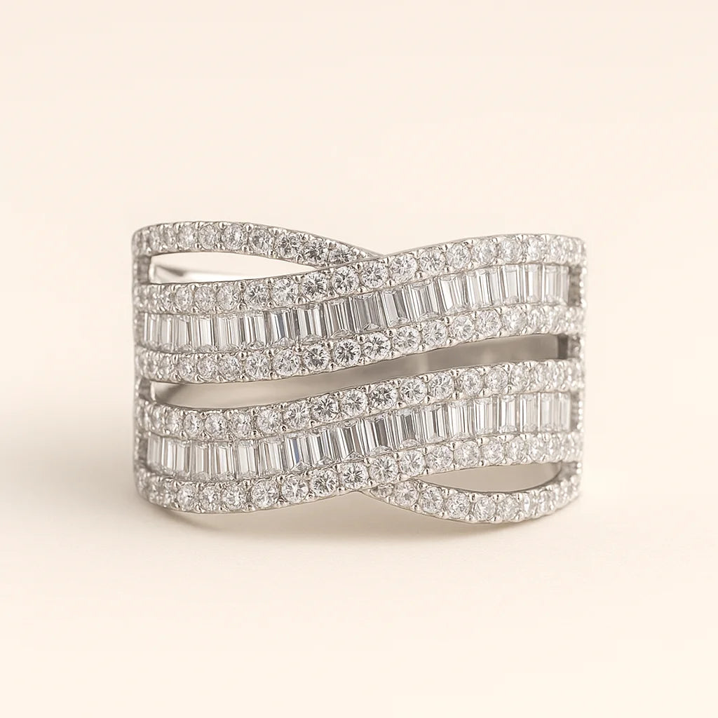 A wide 925 sterling silver statement ring with multiple intertwined bands, featuring a mix of baguette and round cubic zirconia stones.