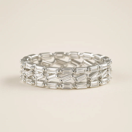A wide 925 sterling silver ring with three interlocking rows of baguette-cut cubic zirconia stones.