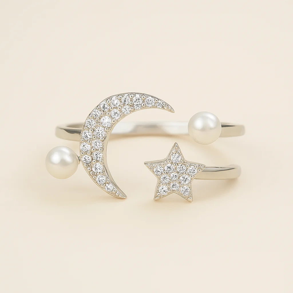 A 925 sterling silver open ring with a crescent moon, star, and faux pearls, all accented with cubic zirconia stones.