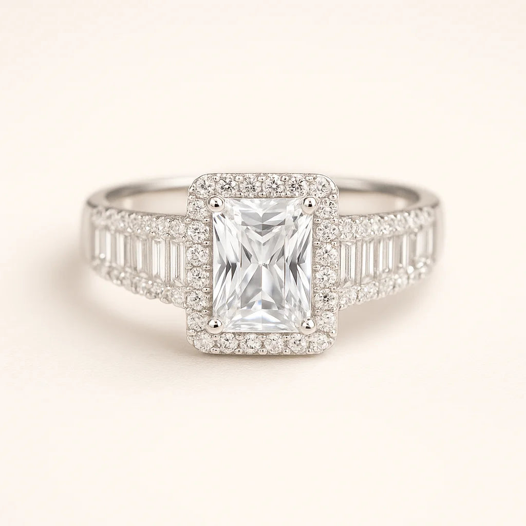 A 925 sterling silver ring with a central emerald-cut cubic zirconia and baguette and pavé stones on the band.