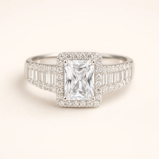 A 925 sterling silver ring with a central emerald-cut cubic zirconia and baguette and pavé stones on the band.