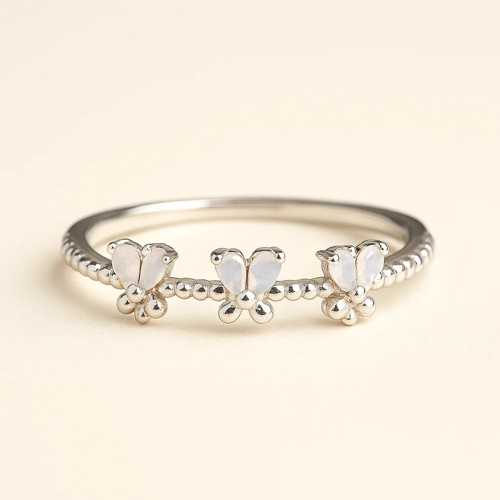 A detailed 925 sterling silver ring featuring three butterflies with opalescent wings and a beaded band.