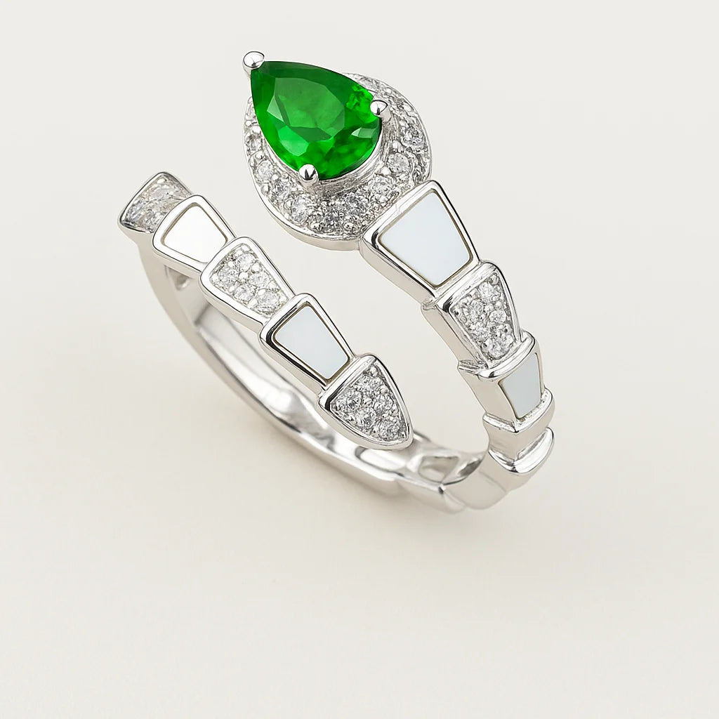 An intricate 925 sterling silver ring in the shape of a serpent, with an emerald-colored pear-cut stone and enamel details.