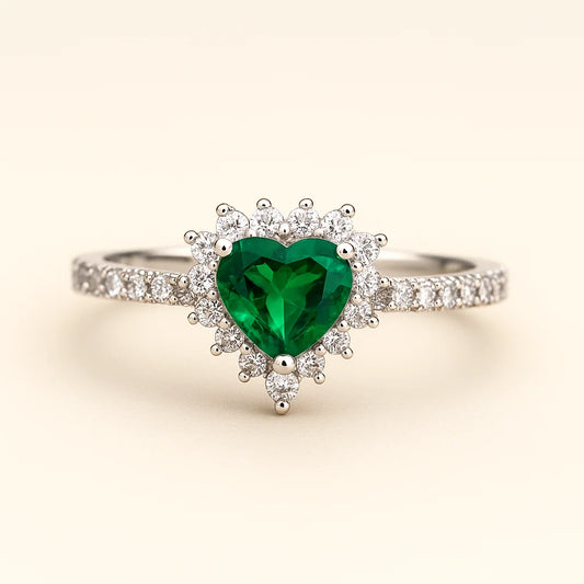 A stunning 925 sterling silver ring featuring a heart-shaped green stone surrounded by a halo of cubic zirconia.