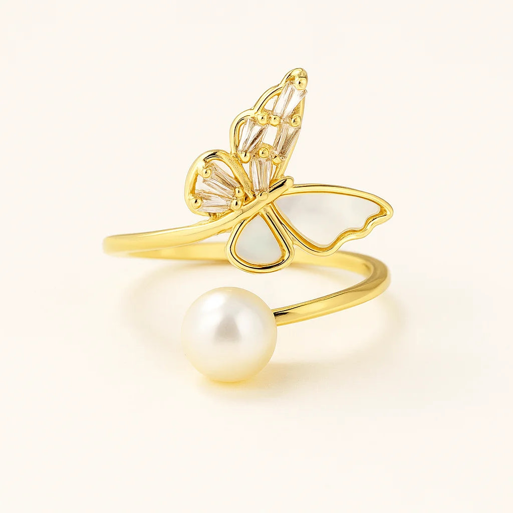 A 925 sterling silver and a gold-plated open-wrap ring with a butterfly centerpiece of mother-of-pearl and baguette cubic zirconia, and a pearl.