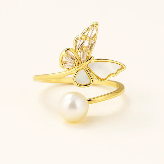 A 925 sterling silver and a gold-plated open-wrap ring with a butterfly centerpiece of mother-of-pearl and baguette cubic zirconia, and a pearl.